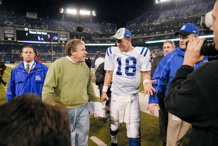 Peter King walks alongside Peyton Manning
